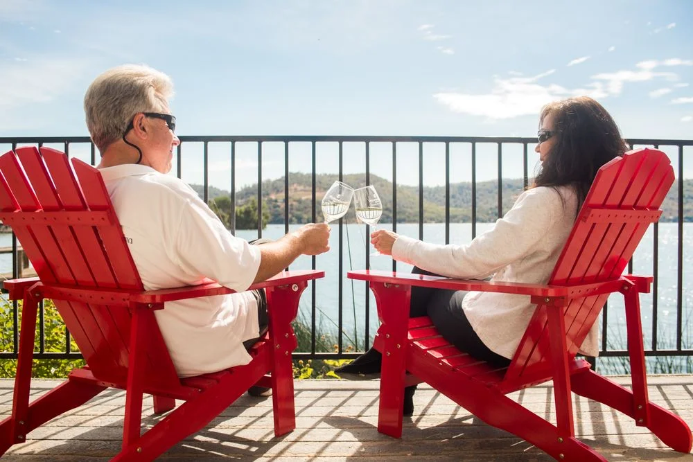 Guests can relax on the patio of one of our lakefront kitchen cottages